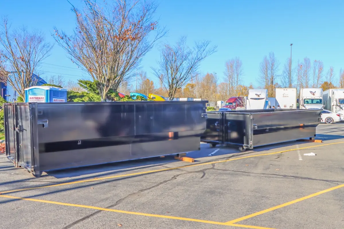 Professional dumpster rental service with roll-off container on residential driveway in Rocky River